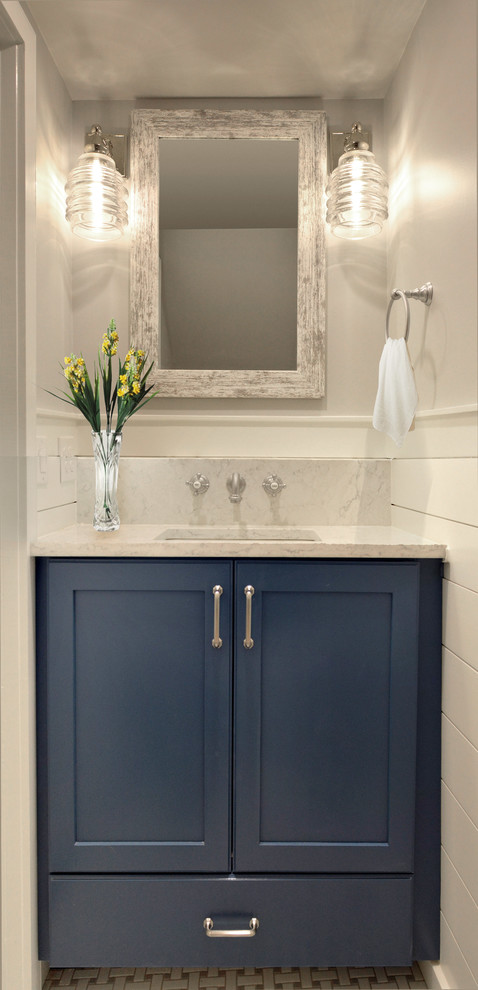 Inspiration for a small transitional powder room with shaker cabinets, blue cabinets, a two-piece toilet, grey walls, ceramic floors, an undermount sink, engineered quartz benchtops, white floor and white benchtops.
