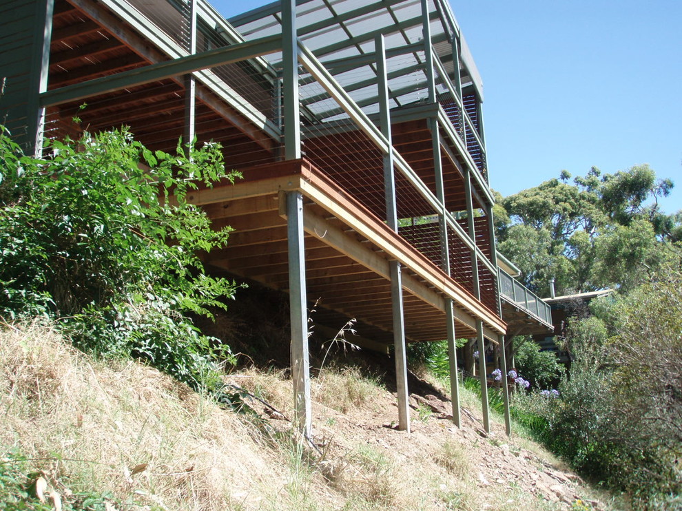 This is an example of a large country backyard deck in Adelaide with a pergola.