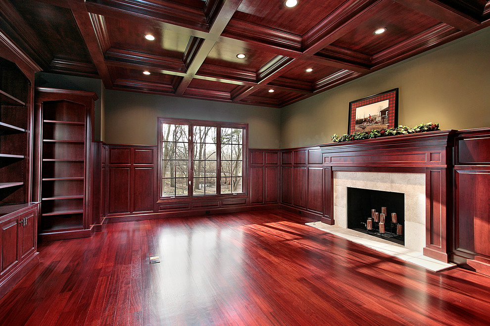 Photo of a large traditional home office in Chicago with green walls, dark hardwood floors, a standard fireplace and a tile fireplace surround.