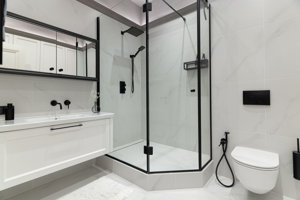 Свежая идея для дизайна: ванная комната среднего размера в стиле неоклассика (современная классика) с белыми фасадами, угловым душем, биде, серой плиткой, керамогранитной плиткой, серыми стенами, полом из керамической плитки, душевой кабиной, подвесной раковиной, серым полом, душем с раздвижными дверями, белой столешницей, гигиеническим душем, тумбой под одну раковину, подвесной тумбой и многоуровневым потолком - отличное фото интерьера