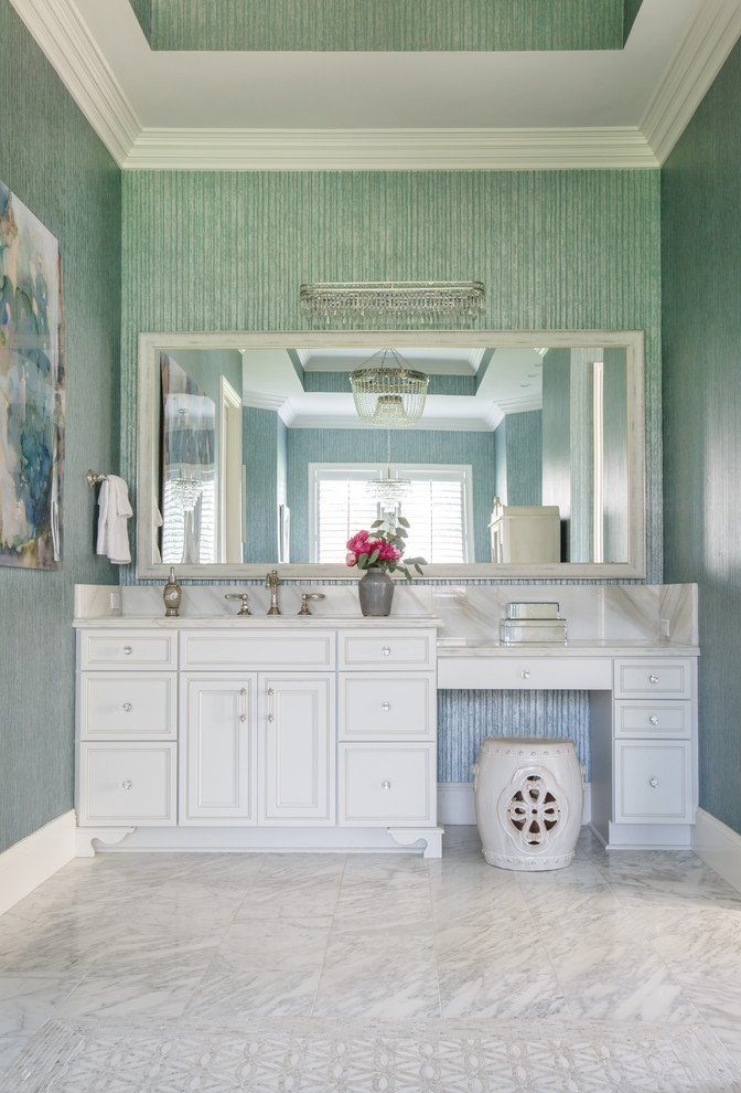 Design ideas for a small beach style bathroom in Jacksonville with white cabinets, a freestanding tub, a bidet, white tile, marble, blue walls, marble floors, an undermount sink, onyx benchtops, white floor, a hinged shower door and raised-panel cabinets.