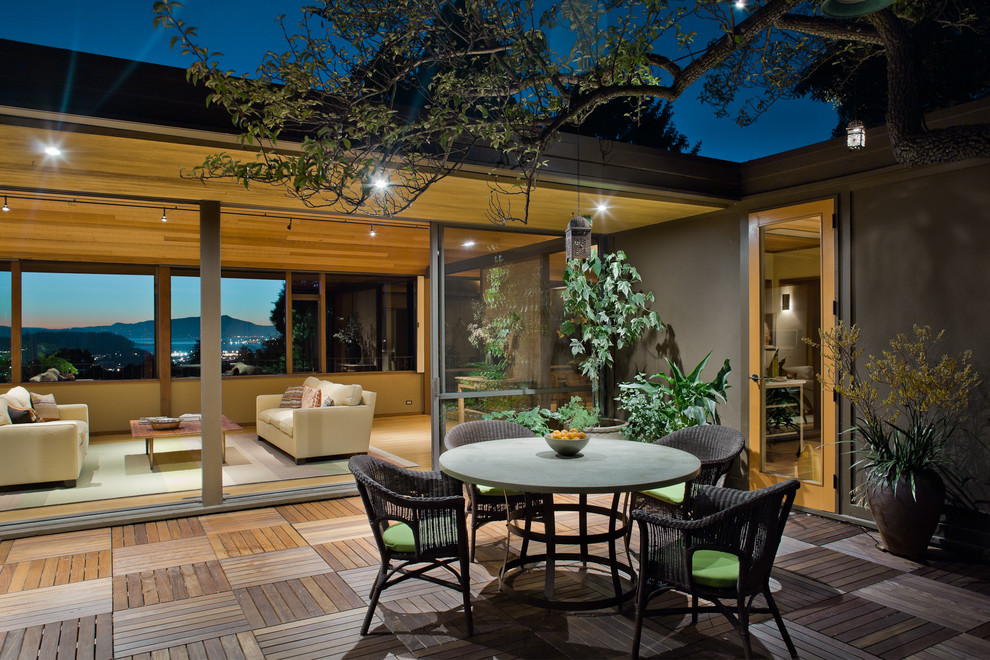 This is an example of a large midcentury courtyard deck in San Francisco with no cover.