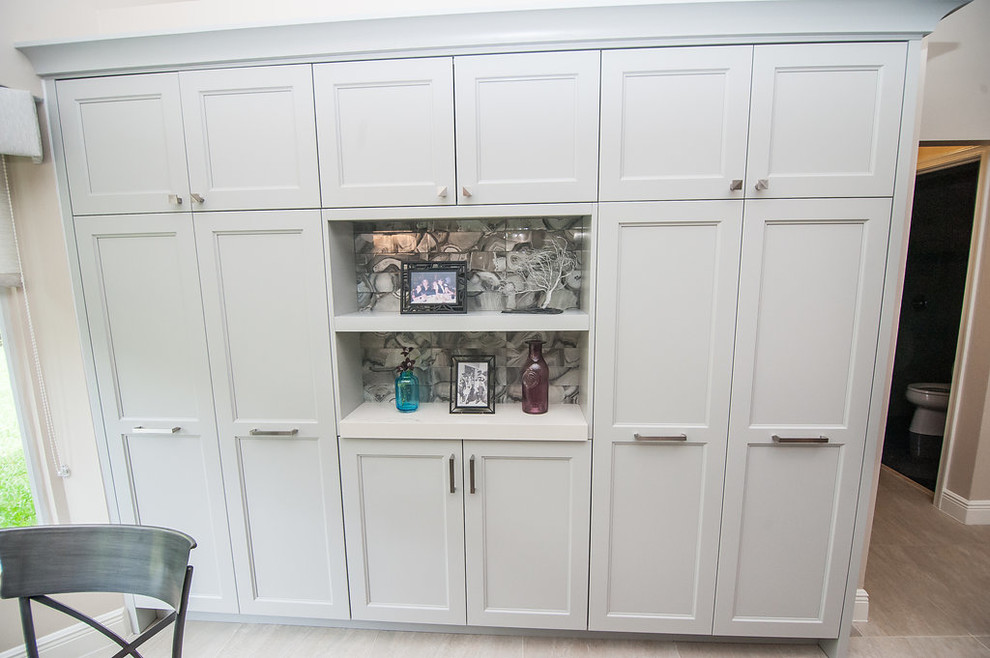 Inspiration for a mid-sized transitional u-shaped porcelain tile and beige floor eat-in kitchen remodel in Miami with an undermount sink, shaker cabinets, gray cabinets, quartz countertops, gray backsplash, glass tile backsplash, stainless steel appliances, an island and white countertops
