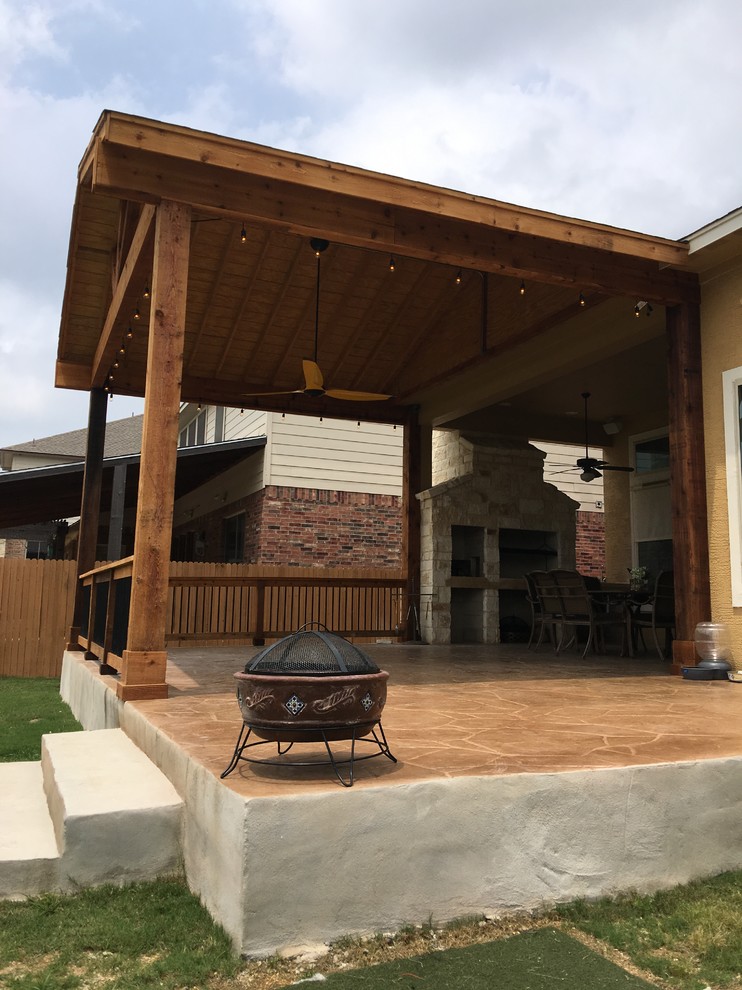 Photo of a large traditional backyard deck in Other with an outdoor kitchen and a roof extension.
