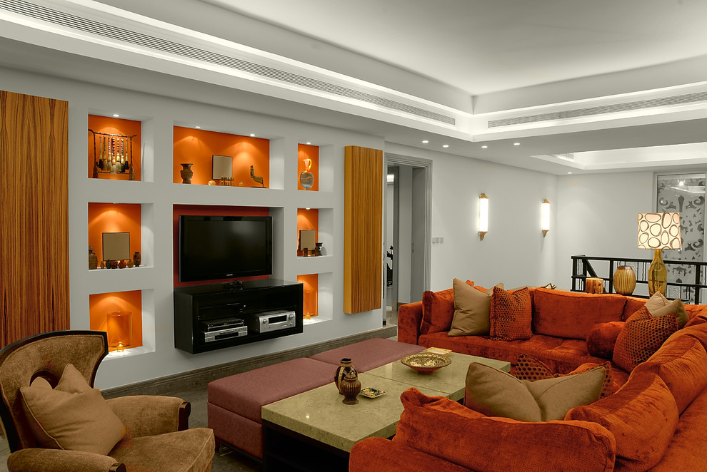 This is an example of a contemporary loft-style family room in Other with orange walls.