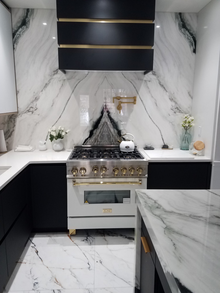 Inspiration for a mid-sized transitional l-shaped eat-in kitchen in New York with an undermount sink, flat-panel cabinets, white cabinets, marble benchtops, white splashback, engineered quartz splashback, white appliances, ceramic floors, with island, white floor, white benchtop and recessed.