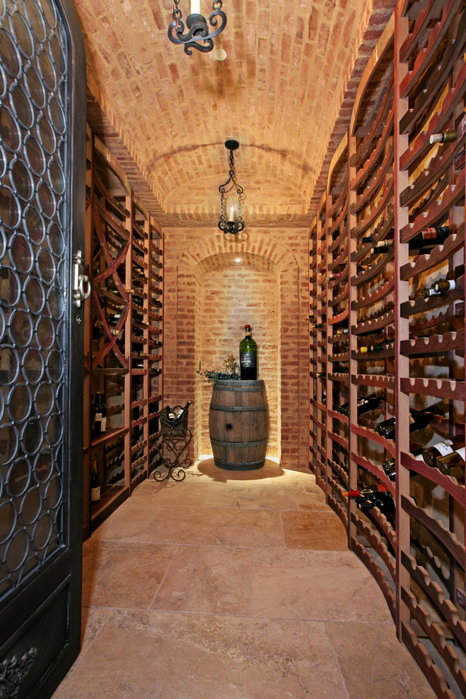 This is an example of a mid-sized mediterranean wine cellar in Orange County with storage racks.