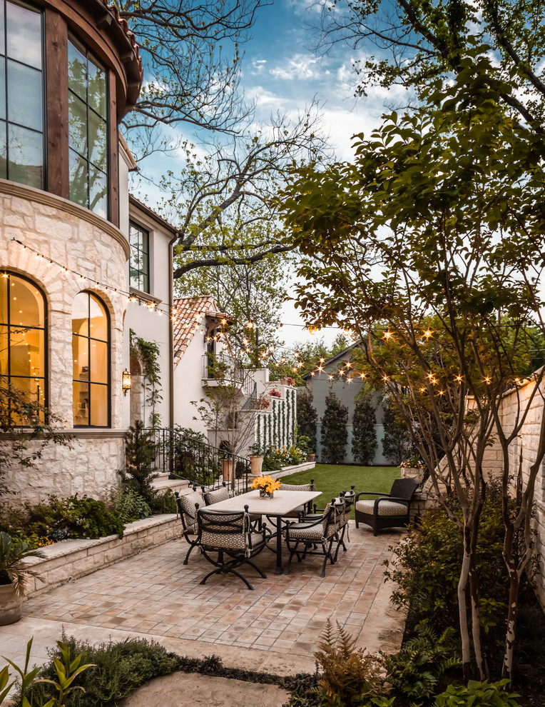 Patio - mediterranean courtyard patio idea in Dallas with a fire pit