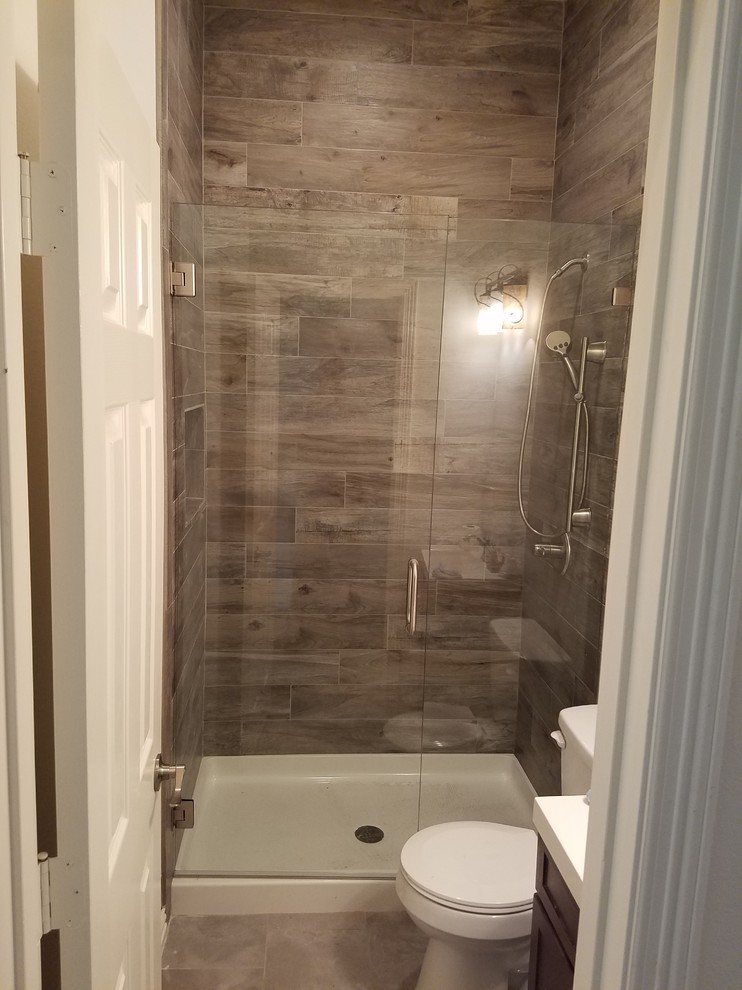 Alcove bathtub - large transitional 3/4 beige tile beige floor alcove bathtub idea in Austin with shaker cabinets, dark wood cabinets, beige walls and a hinged shower door
