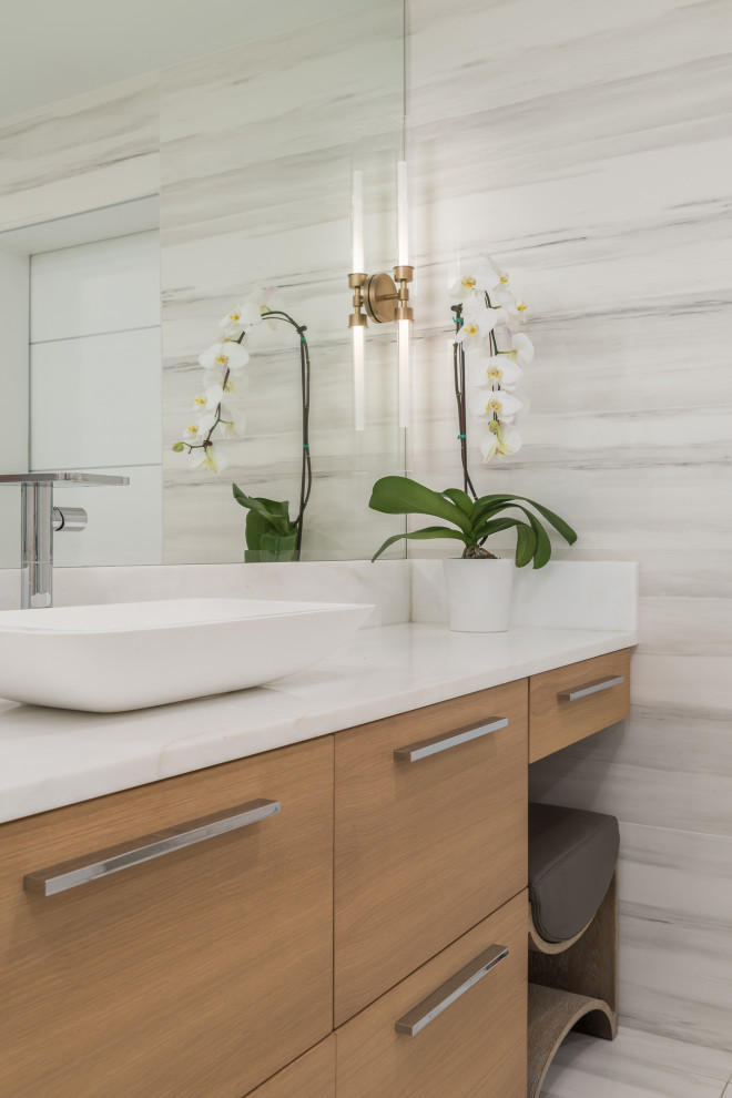 Large trendy master multicolored tile and porcelain tile porcelain tile, multicolored floor and single-sink bathroom photo in Tampa with flat-panel cabinets, light wood cabinets, a bidet, white walls, a vessel sink, onyx countertops, a hinged shower door, white countertops and a floating vanity