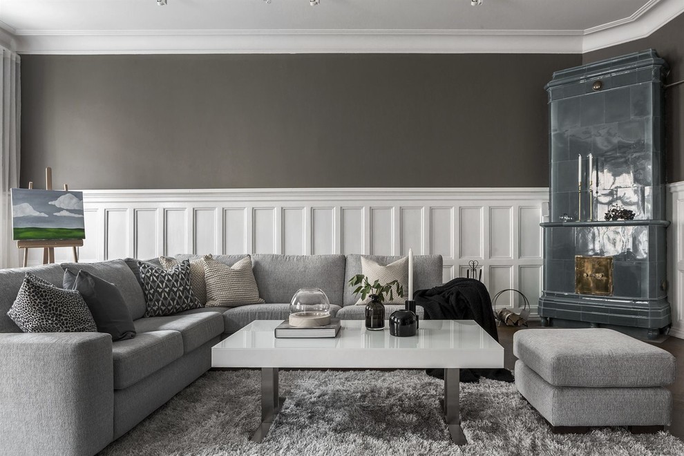 Inspiration for a large traditional formal enclosed living room in Stockholm with grey walls, a standard fireplace and a tile fireplace surround.