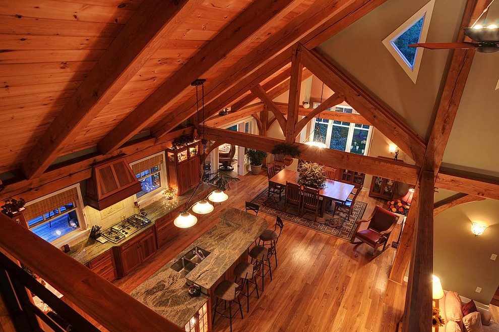 Inspiration for a mid-sized rustic galley medium tone wood floor eat-in kitchen remodel in Milwaukee with an undermount sink, recessed-panel cabinets, medium tone wood cabinets, white backsplash, ceramic backsplash and an island