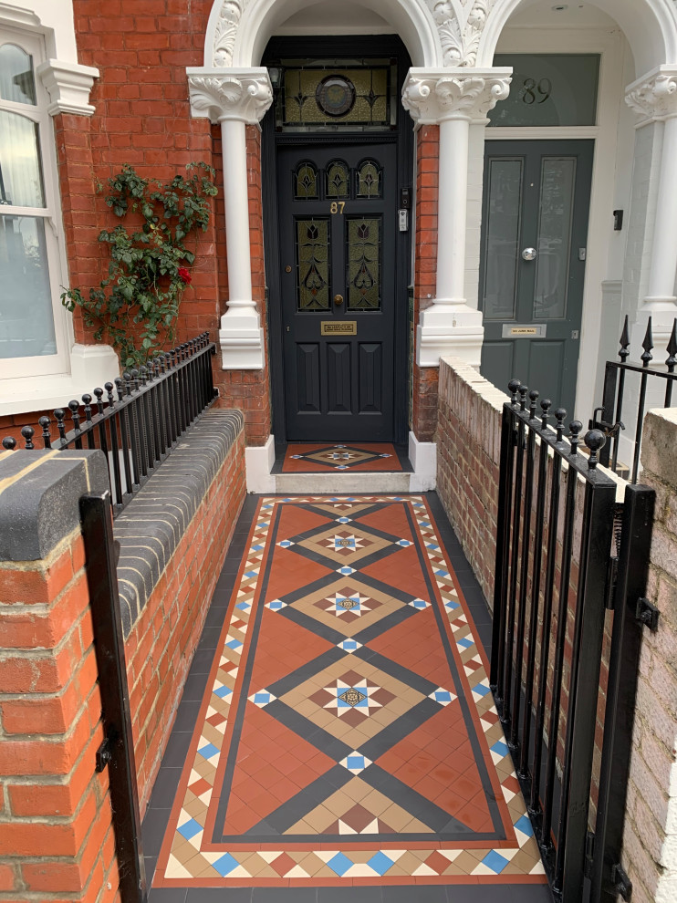 Traditional entryway in London with ceramic floors and brown floor.