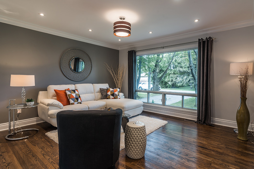 Mid-sized contemporary open concept living room in Montreal with grey walls and medium hardwood floors.