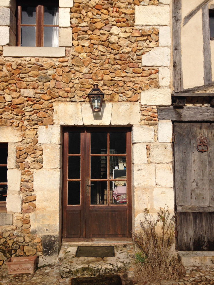 Inspiration for a small rustic front door remodel with beige walls and a medium wood front door