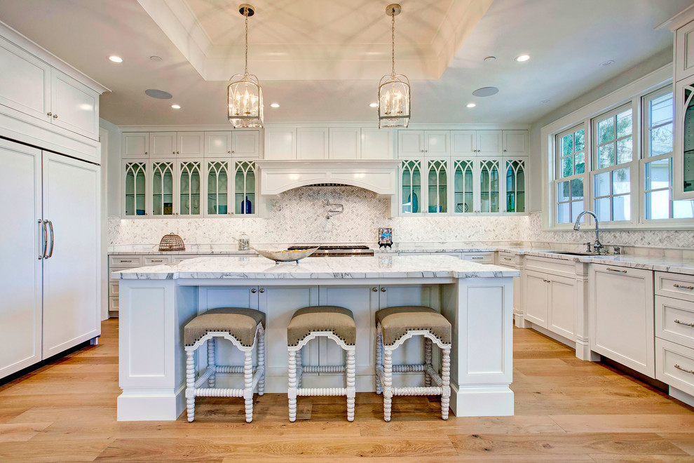 Inspiration for a traditional kitchen in Los Angeles with light hardwood floors and with island.