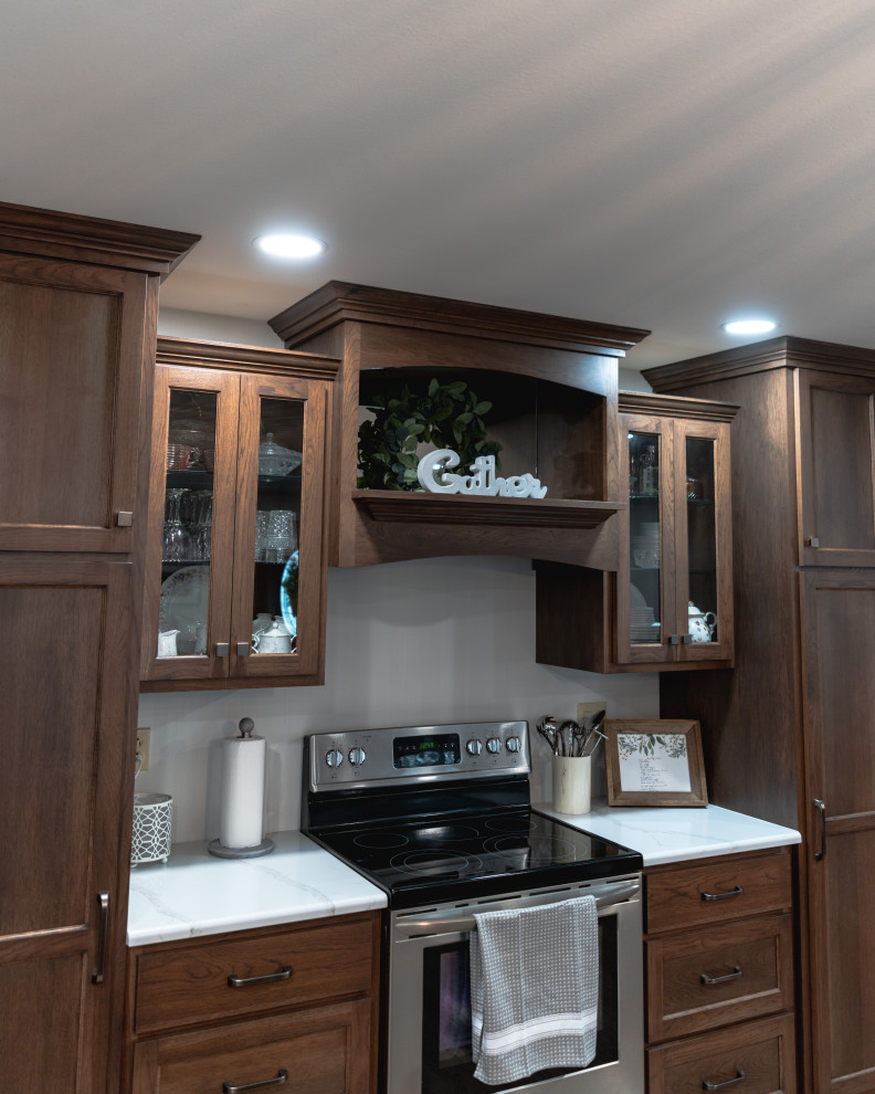 Inspiration for a huge transitional l-shaped medium tone wood floor and brown floor open concept kitchen remodel with shaker cabinets, medium tone wood cabinets, quartz countertops, stainless steel appliances, an island and white countertops