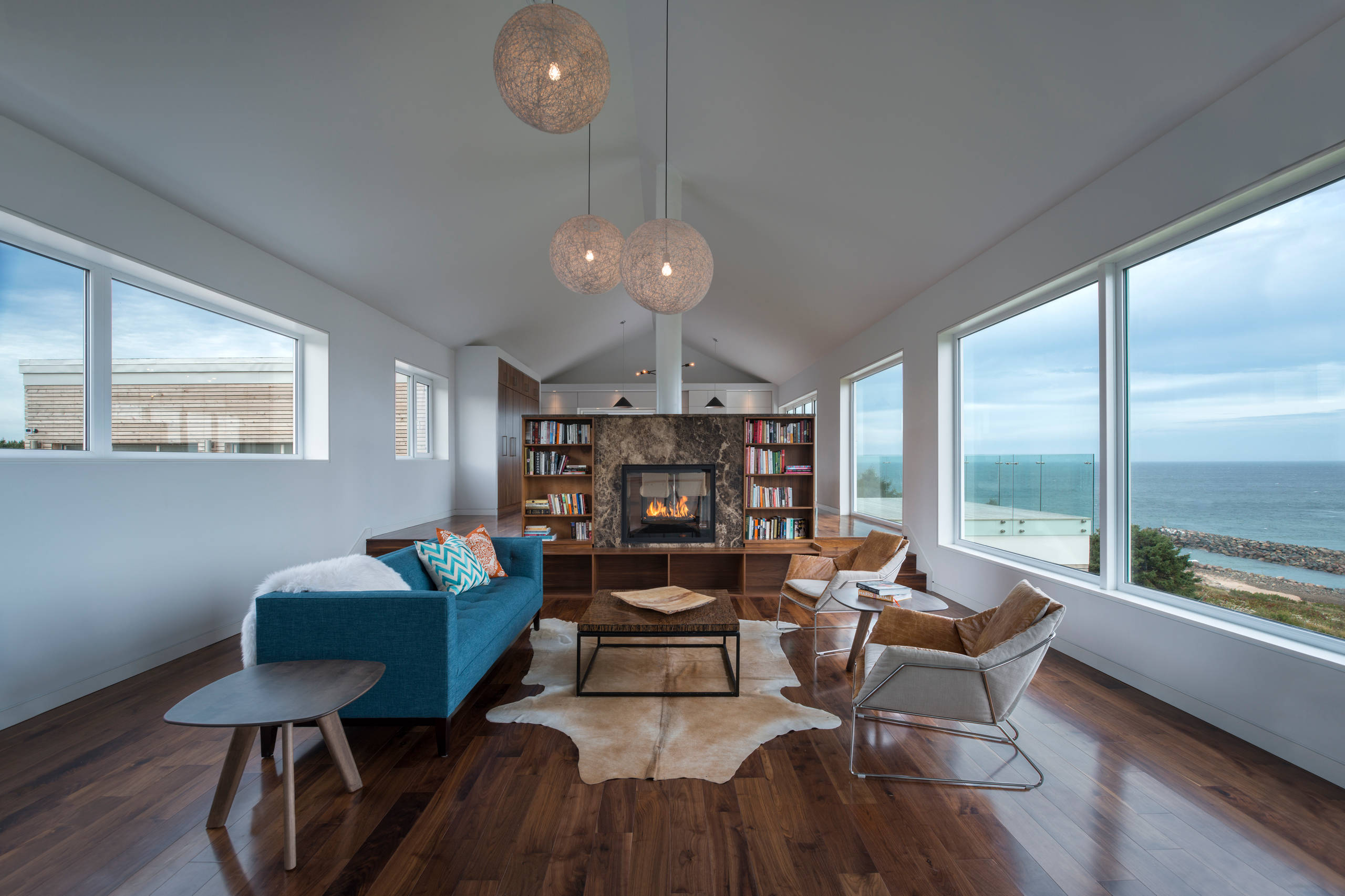 Jill Greaves Design in collaboration with Omar Gandhi Architect.  A multi-level, residential retreat complete with full-length cathedral ceiling, hardwood floors and panorama views.  A central hearth,