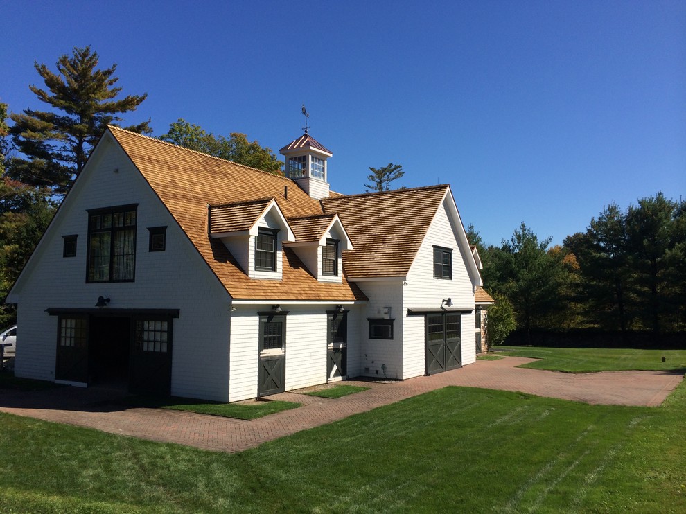 Design ideas for a large arts and crafts two-storey white exterior in New York with wood siding and a gable roof.