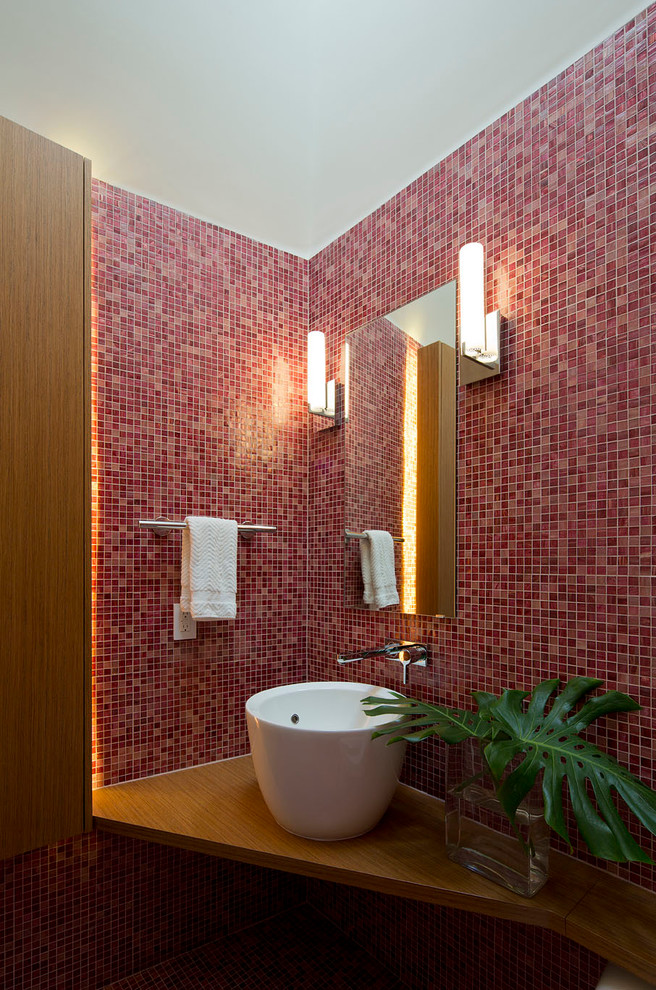 This is an example of a large contemporary powder room in Austin with a vessel sink, red tile, mosaic tile, red walls, wood benchtops and brown benchtops.