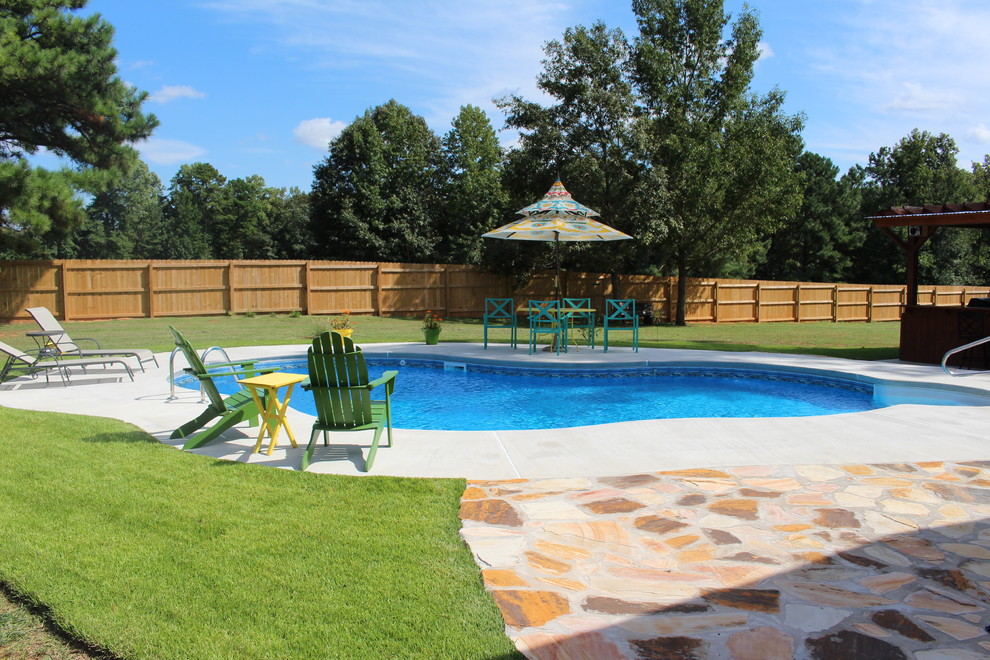 Design ideas for a mid-sized traditional backyard custom-shaped pool in Atlanta.