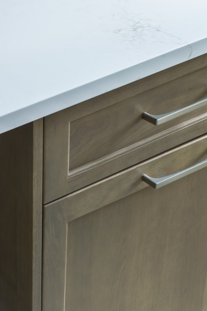 Mid-sized transitional l-shaped ceramic tile and beige floor eat-in kitchen photo in Chicago with an undermount sink, flat-panel cabinets, beige cabinets, quartz countertops, beige backsplash, ceramic backsplash, stainless steel appliances, an island and white countertops