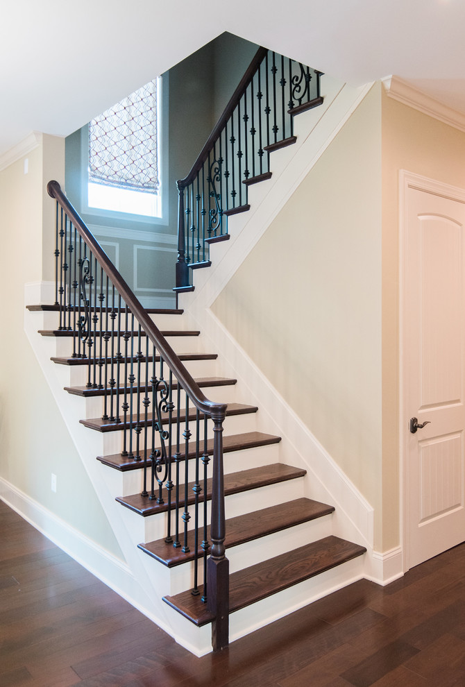 Design ideas for a large transitional wood curved staircase in Baltimore with painted wood risers and wood railing.