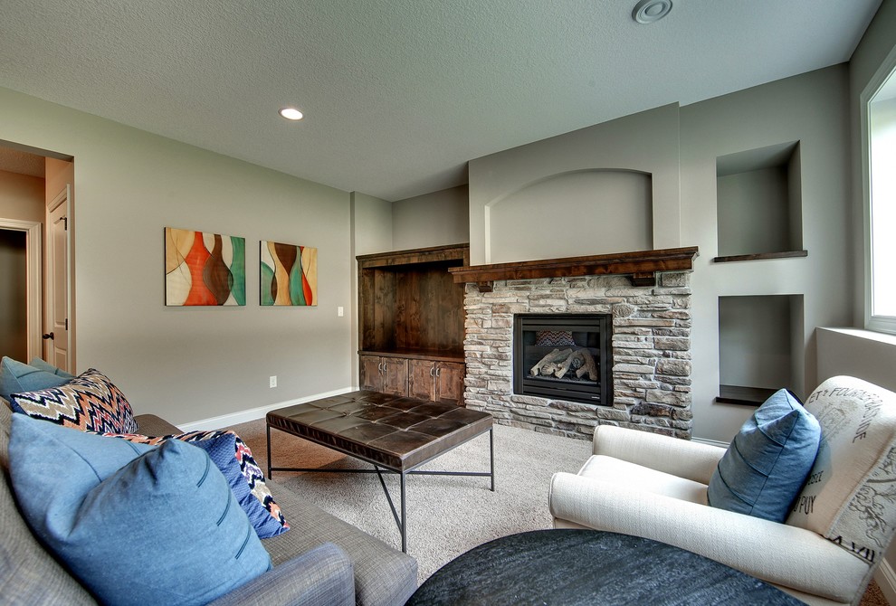 Design ideas for a large traditional walk-out basement in Minneapolis with grey walls, carpet, a standard fireplace and a stone fireplace surround.