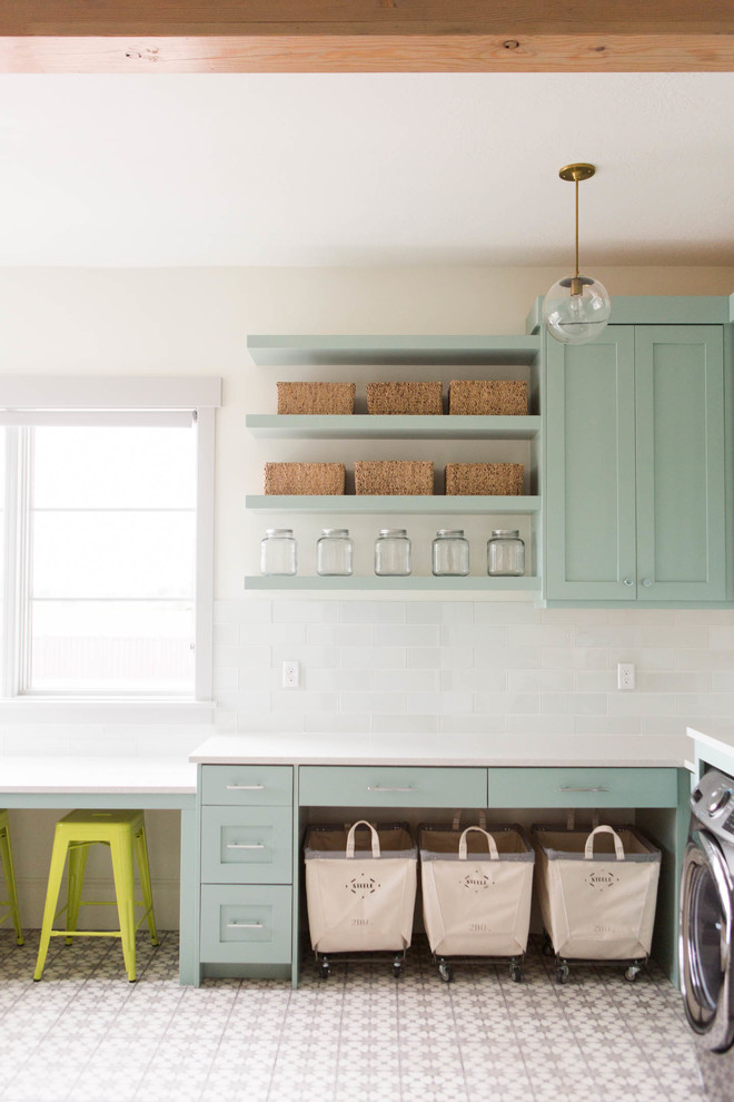 Inspiration for a transitional l-shaped dedicated laundry room in Salt Lake City with shaker cabinets, white walls, a side-by-side washer and dryer and blue cabinets.