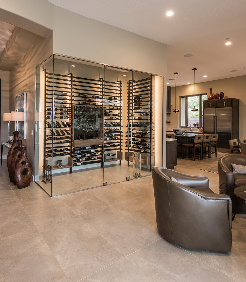 Photo of a large contemporary wine cellar in Phoenix with porcelain floors, display racks and beige floor.
