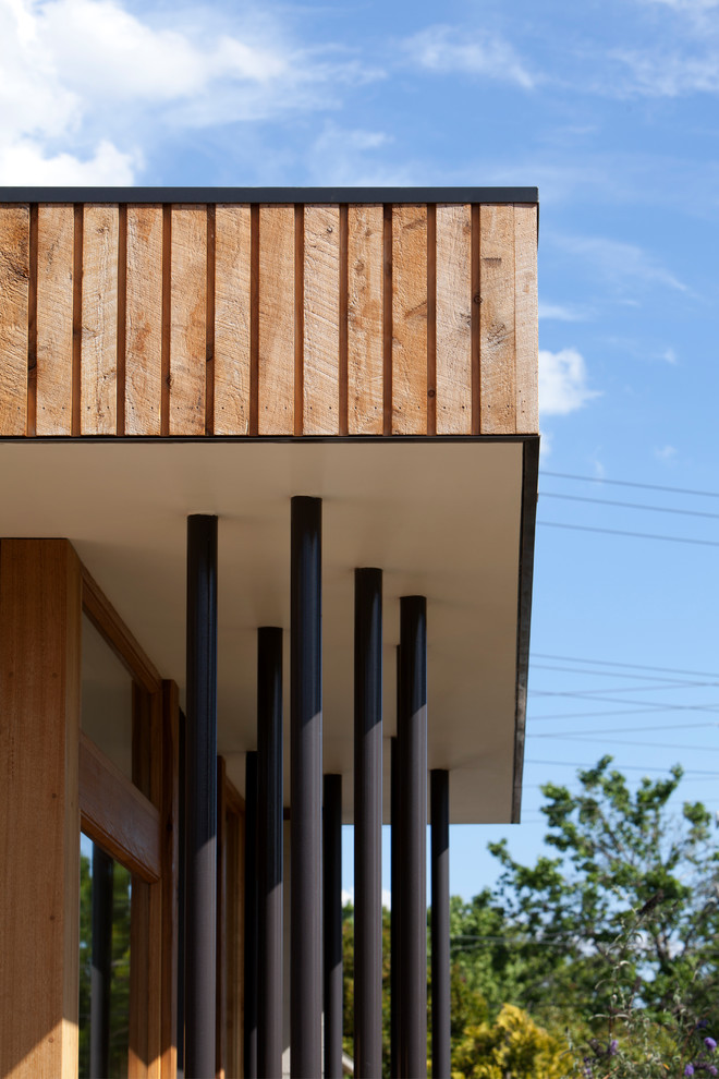 This is an example of a contemporary one-storey exterior in Melbourne with wood siding.