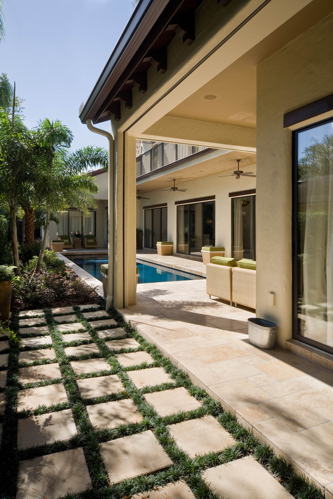 Inspiration for a mediterranean backyard patio in Orlando with a roof extension.