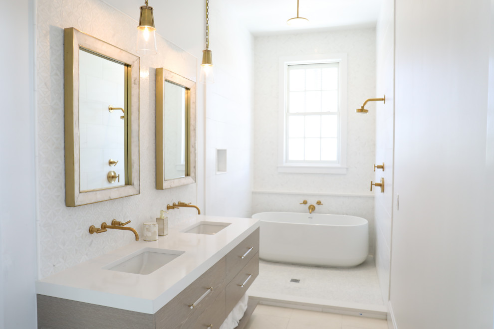 Design ideas for a mid-sized beach style master bathroom in Other with flat-panel cabinets, light wood cabinets, a freestanding tub, a shower/bathtub combo, a one-piece toilet, white tile, mosaic tile, white walls, travertine floors, an undermount sink, quartzite benchtops, white floor, a hinged shower door, white benchtops, an enclosed toilet, a double vanity, a floating vanity and vaulted.