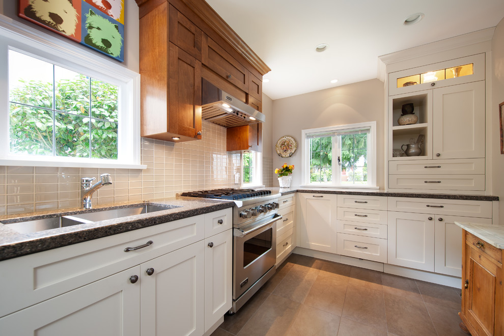 Photo of a contemporary kitchen in Vancouver with glass tile splashback, stainless steel appliances, beige splashback, a double-bowl sink, shaker cabinets and white cabinets.