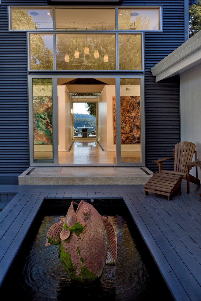This is an example of a contemporary deck in San Francisco with a water feature.