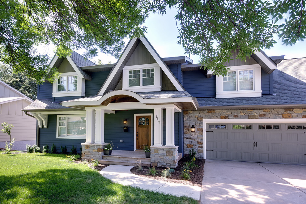 Inspiration for a mid-sized traditional two-storey exterior in Minneapolis with wood siding.
