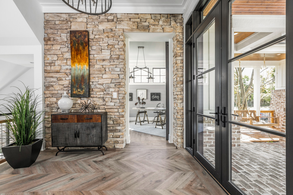 Design ideas for an expansive country foyer in Indianapolis with white walls, light hardwood floors, a double front door, a black front door and multi-coloured floor.
