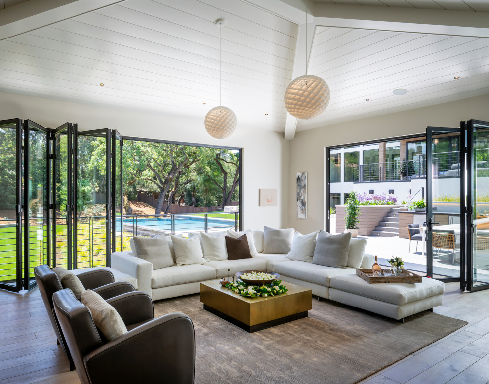 This is an example of an expansive contemporary sunroom in San Francisco with porcelain floors, beige floor and a standard ceiling.