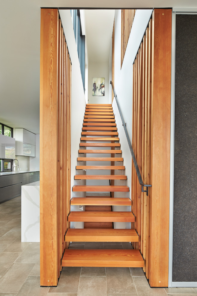 Inspiration for a contemporary wood straight staircase in Seattle with open risers.