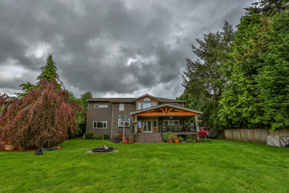 Inspiration for a large rustic two-story wood brown deck remodel in Seattle with a hip roof and a shingle roof