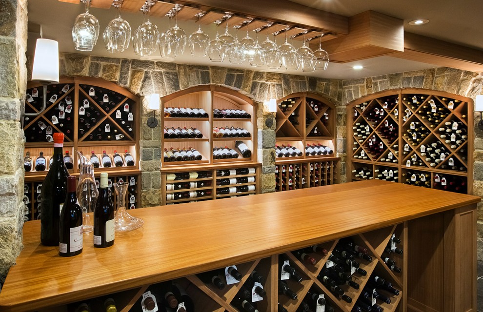 Photo of a large country wine cellar in Boston with slate floors and diamond bins.