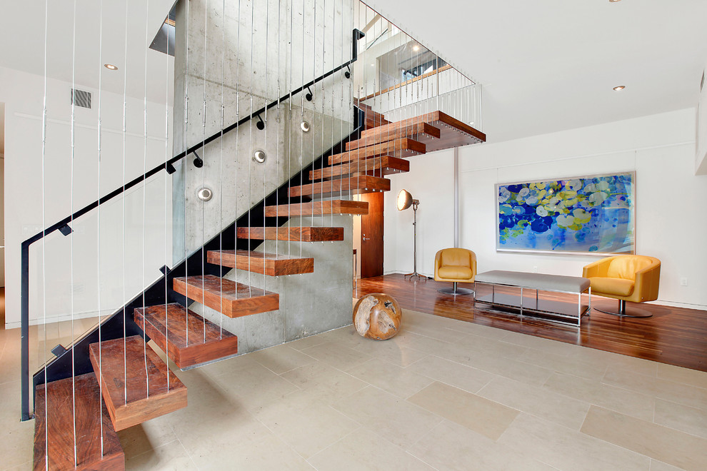 Modern wood floating staircase in Portland with open risers and cable railing.