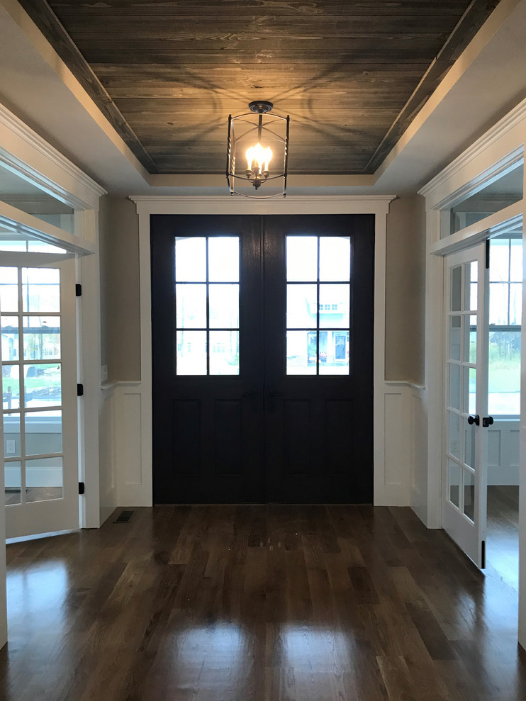 Large arts and crafts foyer in New York with grey walls, a double front door and a dark wood front door.