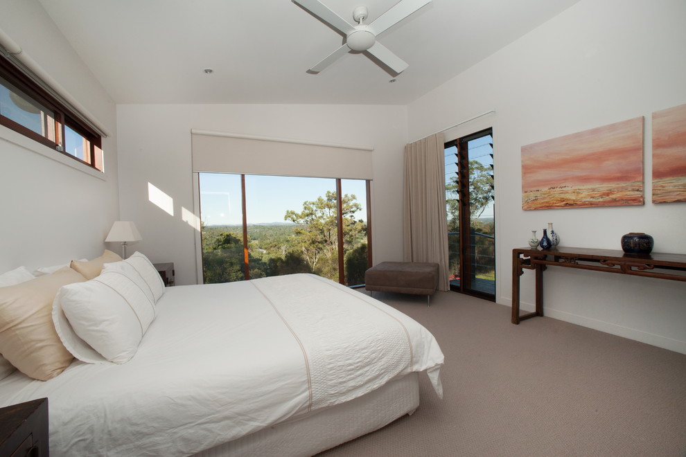 Photo of a large contemporary guest bedroom in Brisbane with white walls and carpet.