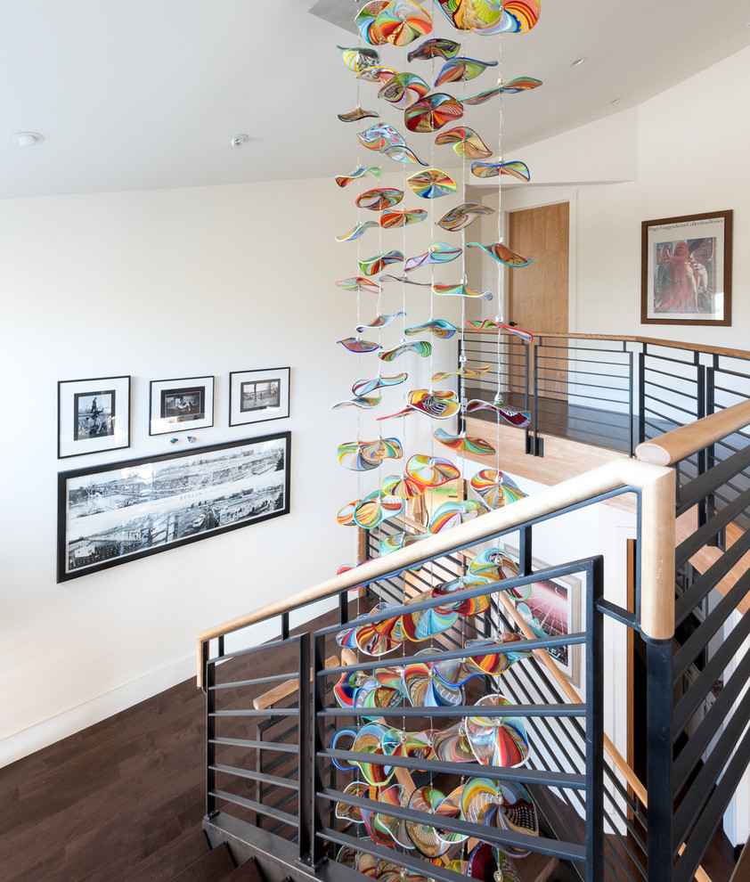 Large contemporary wood u-shaped staircase in Denver with wood risers and wood railing.