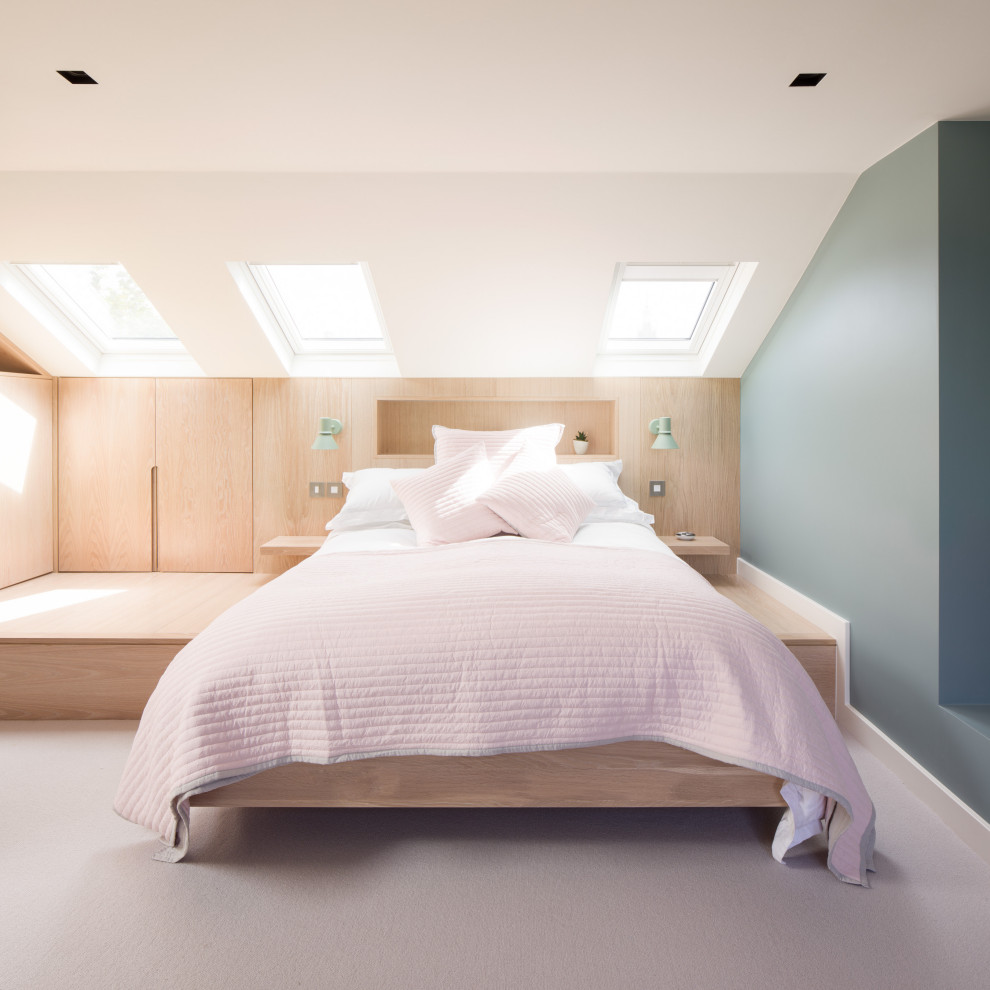 This is an example of a contemporary bedroom in London with green walls, carpet, grey floor and vaulted.