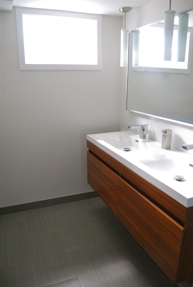 Small modern bathroom in Kansas City with flat-panel cabinets and gray tile.