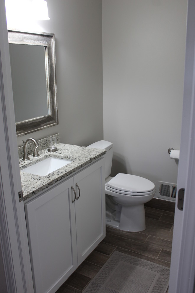 Design ideas for a small transitional 3/4 bathroom in Detroit with shaker cabinets, white cabinets, a two-piece toilet, ceramic floors, an undermount sink, engineered quartz benchtops and grey floor.