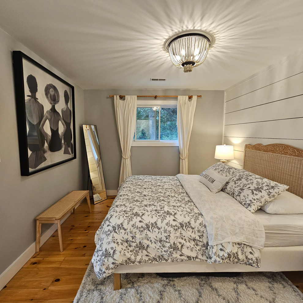 Nautical master bedroom in Toronto with grey walls and medium hardwood flooring.