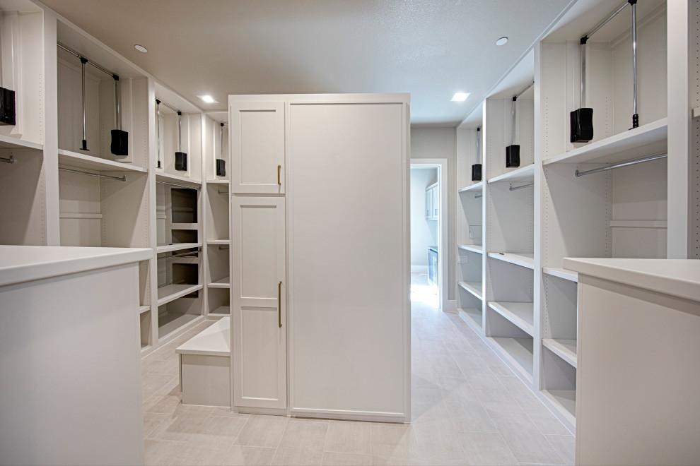 Large elegant gender-neutral walk-in closet photo in Dallas with shaker cabinets